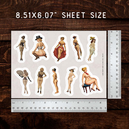 Sheet of stickers with illustrated women on a wooden surface with a ruler for scale.