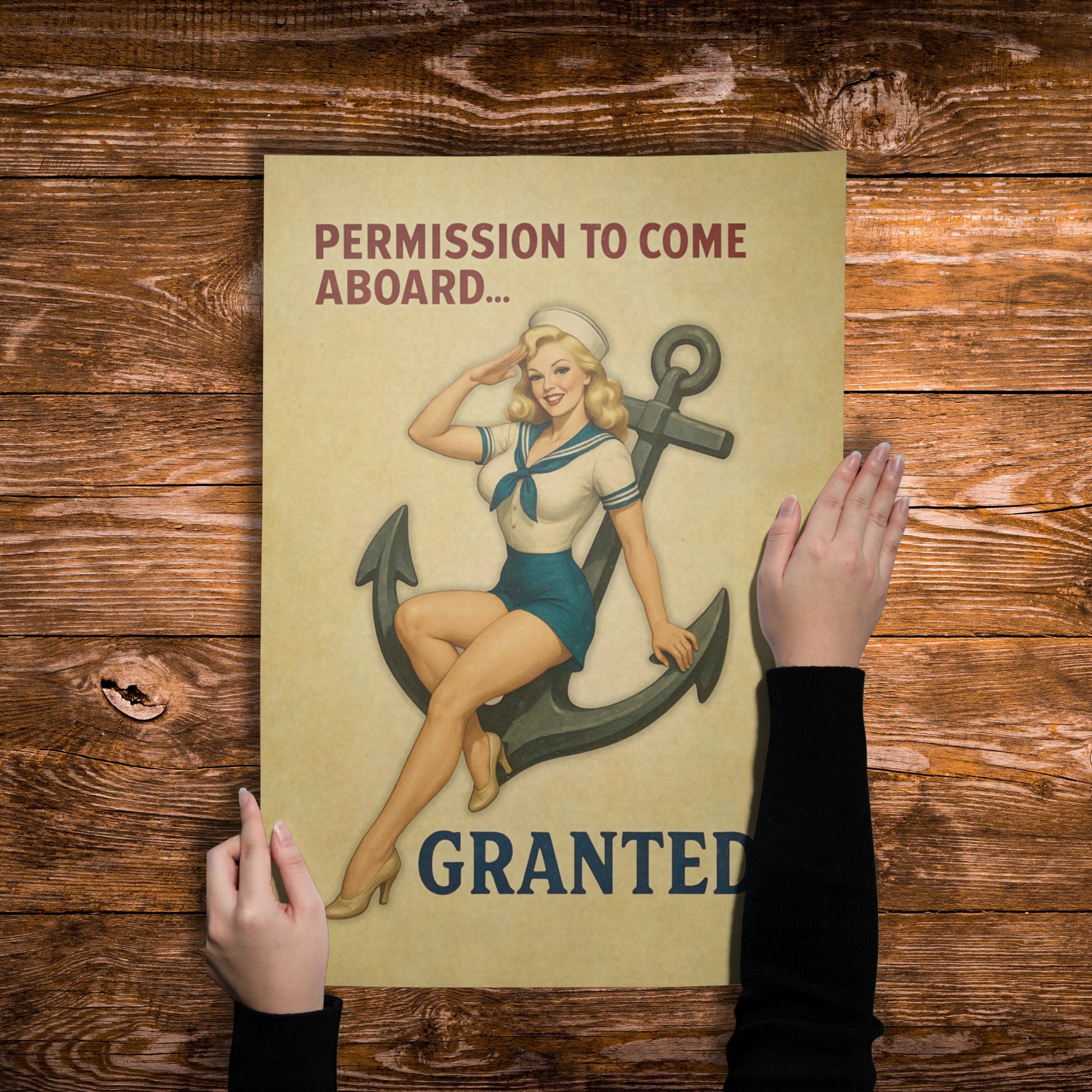Poster with a vintage-style illustration of a woman in a sailor outfit and anchor, held up against a wooden background.