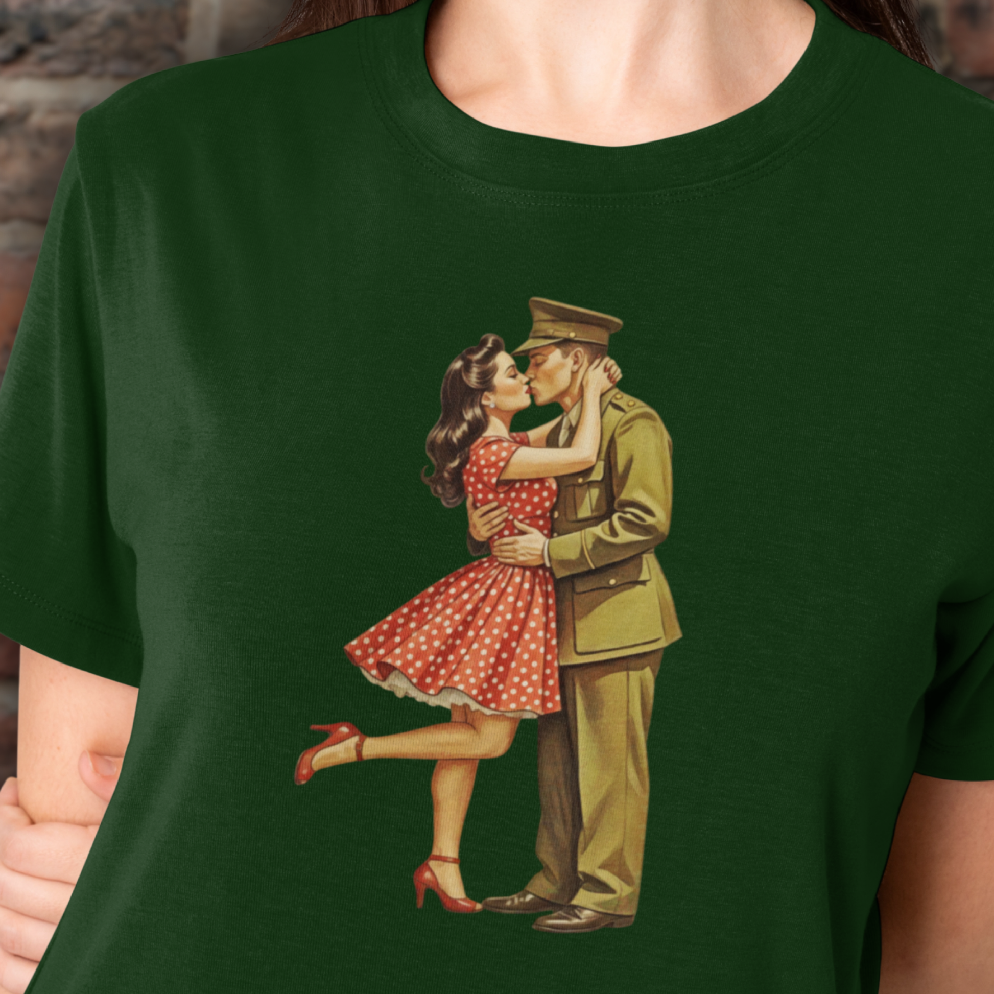 Green t-shirt with a vintage-style graphic of a soldier and a woman in a red dress, worn by a person.