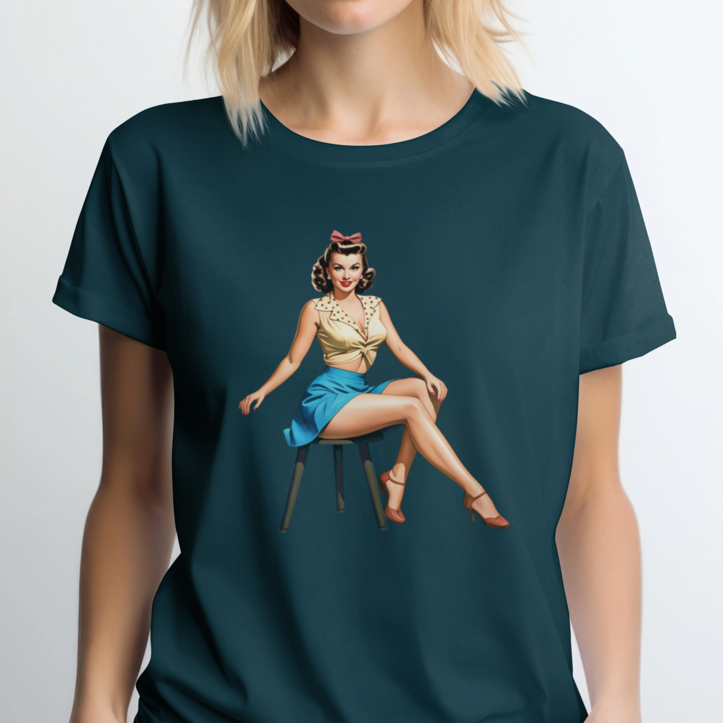 Person wearing a dark green t-shirt with a graphic of a woman sitting on a chair.