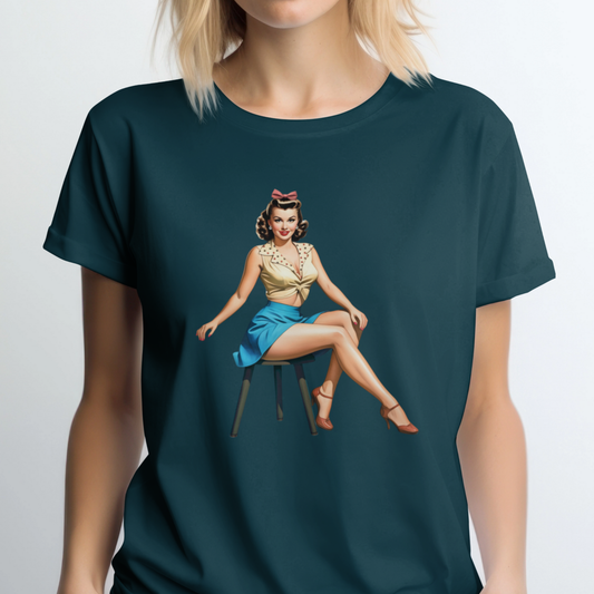 Person wearing a dark green t-shirt with a graphic of a woman sitting on a chair.