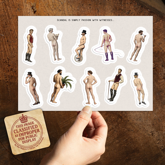 Sheet of stickers with nude figures on a wooden surface with a 'Mature Content' label.